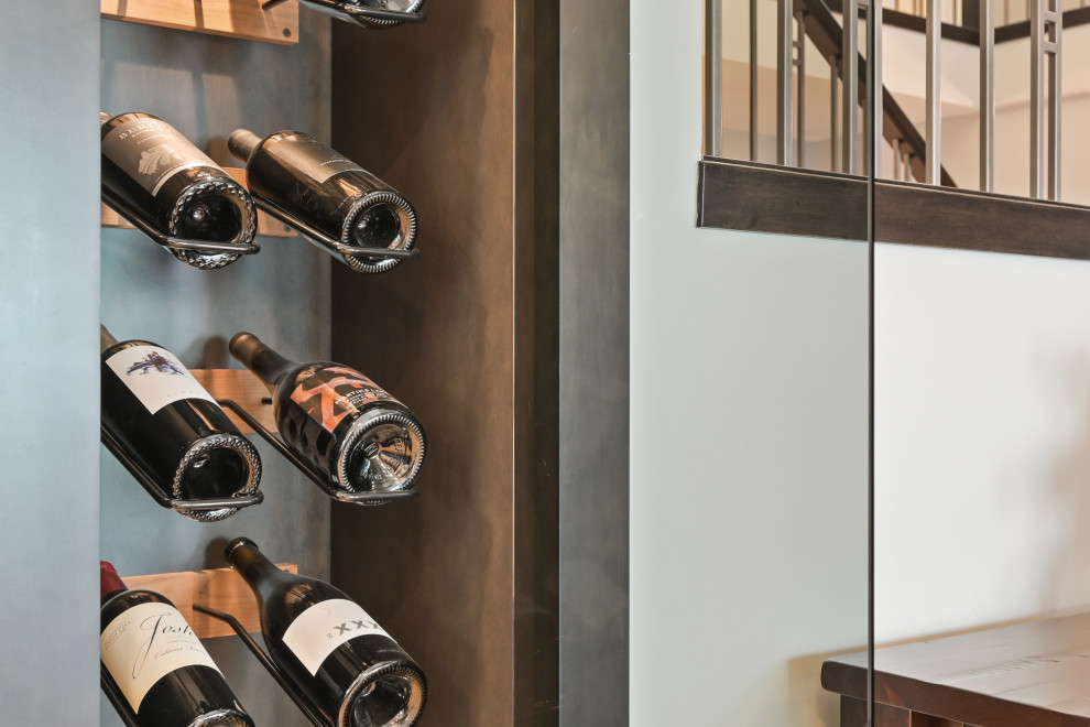 Inspiration for a mid-sized contemporary medium tone wood floor and brown floor wine cellar remodel in Calgary with storage racks