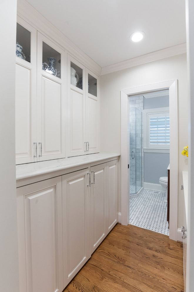 This is an example of a small transitional laundry room in Charlotte.