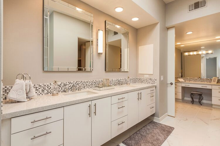Design ideas for a large midcentury master bathroom in Phoenix with flat-panel cabinets, white cabinets, a freestanding tub, an open shower, white tile, grey walls, porcelain floors, a drop-in sink, solid surface benchtops, white floor, an open shower, white benchtops, a double vanity and a built-in vanity.