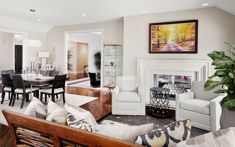 Transitional open concept family room in Chicago with grey walls, dark hardwood floors and a two-sided fireplace.