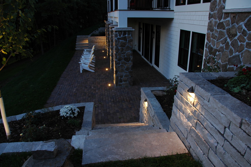 Patio - mid-sized traditional backyard brick patio idea in Minneapolis with a roof extension