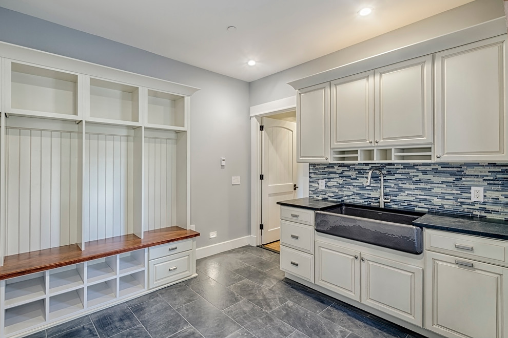 Mid-sized country single-wall eat-in kitchen in Baltimore with a farmhouse sink, raised-panel cabinets, white cabinets, marble benchtops, multi-coloured splashback, glass tile splashback, stainless steel appliances, marble floors, no island and blue floor.