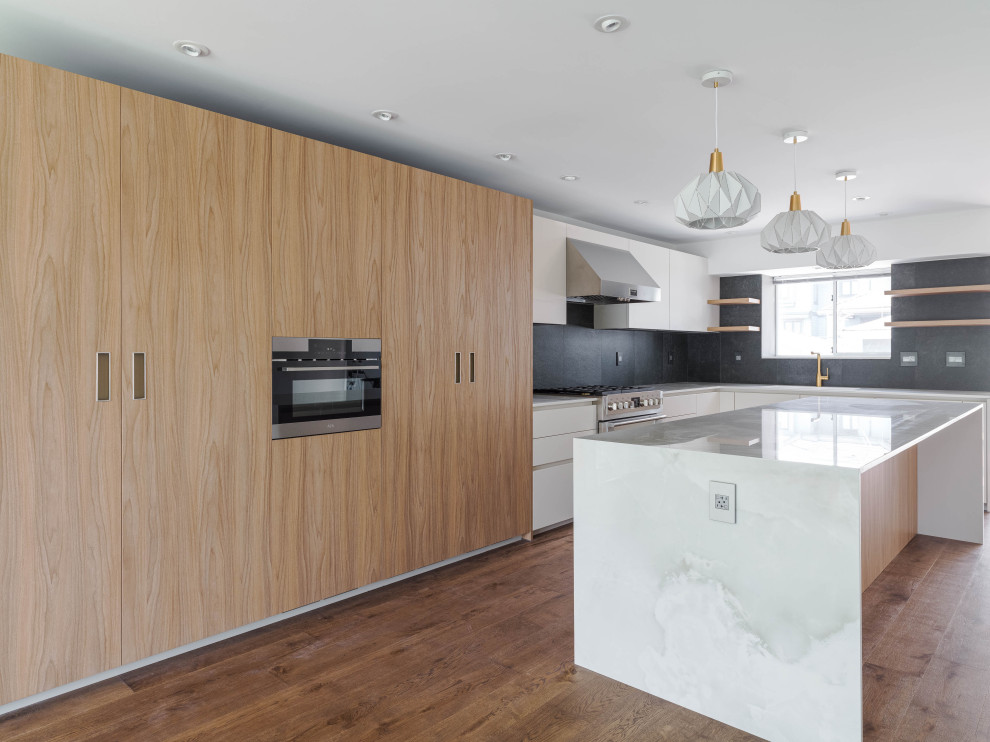 Photo of a large contemporary eat-in kitchen in Vancouver with flat-panel cabinets, light wood cabinets, quartz benchtops, with island and white benchtop.