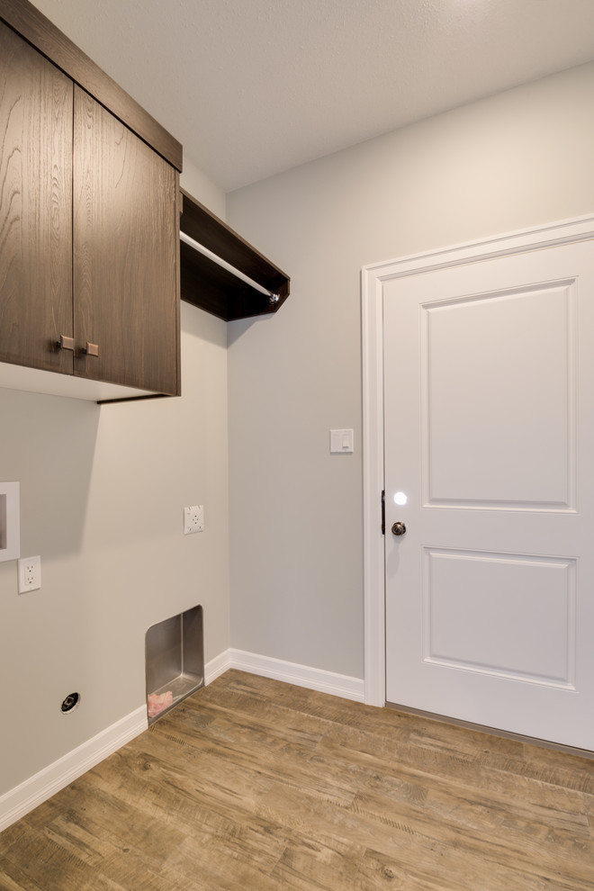 Mid-sized transitional single-wall dedicated laundry room photo with flat-panel cabinets, dark wood cabinets and a side-by-side washer/dryer