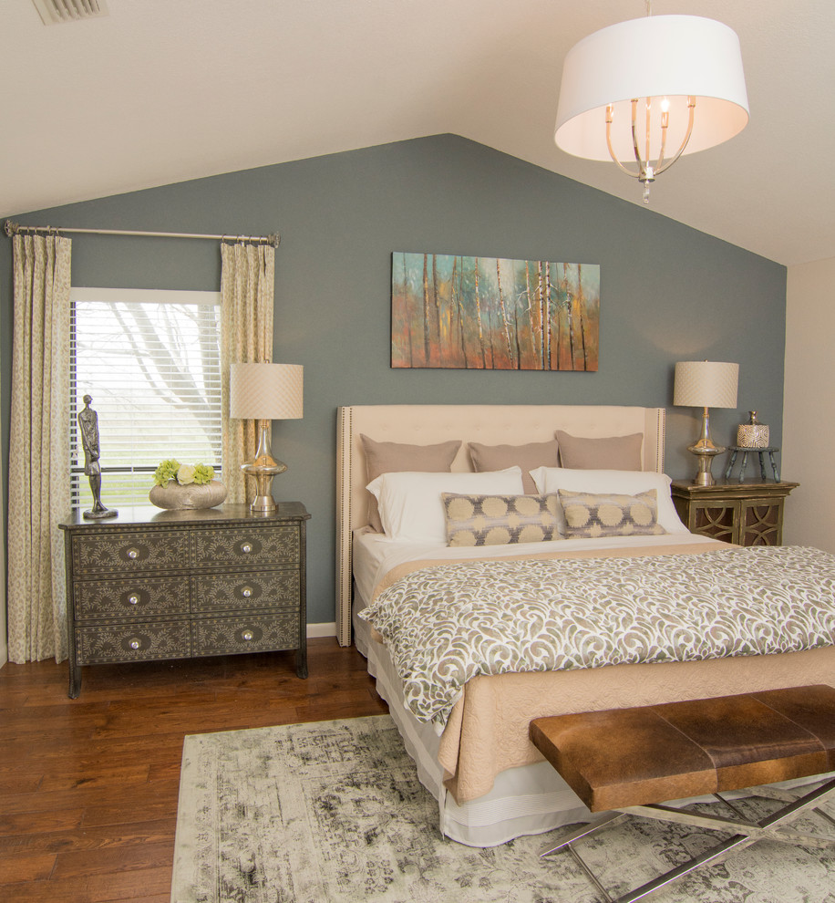 This is an example of a transitional bedroom in Dallas with blue walls and dark hardwood floors.