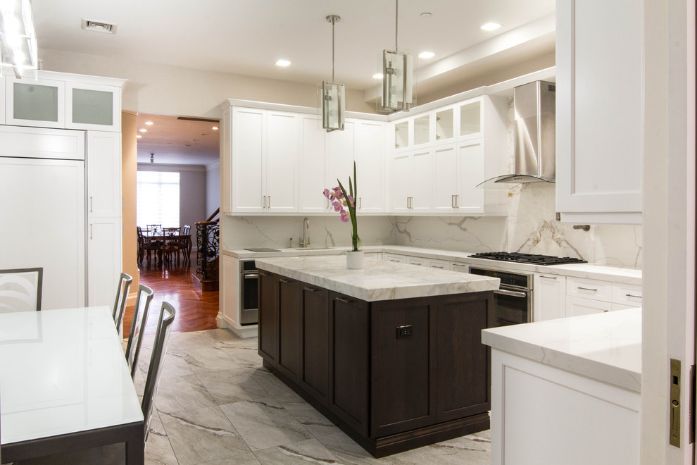 Large transitional u-shaped eat-in kitchen in New York with an undermount sink, recessed-panel cabinets, white cabinets, quartzite benchtops, white splashback, stone slab splashback, stainless steel appliances, ceramic floors, with island and multi-coloured floor.