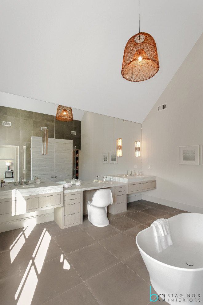 Design ideas for a large contemporary bathroom in New York with white walls, light hardwood floors, beige floor and vaulted.