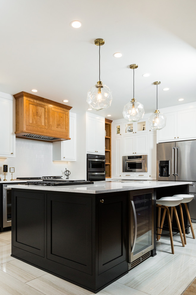 Inspiration for a mid-sized transitional l-shaped porcelain tile and beige floor enclosed kitchen remodel in Albuquerque with shaker cabinets, white cabinets, quartz countertops, white backsplash, mosaic tile backsplash, stainless steel appliances, an island and white countertops