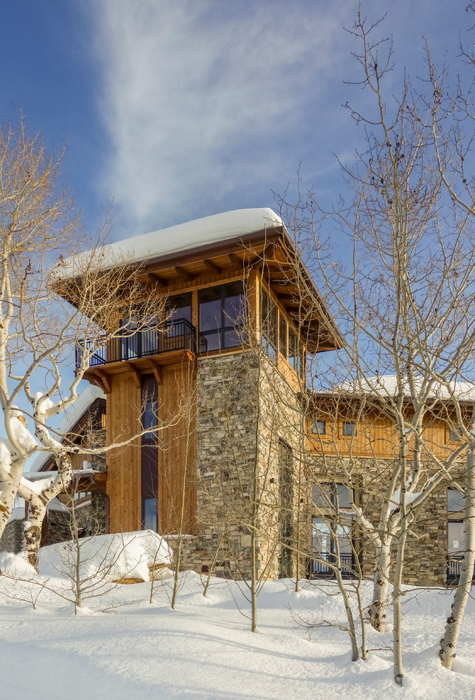 Inspiration for a large rustic brown two-story mixed siding flat roof remodel in Denver with a green roof
