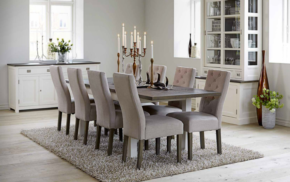 Photo of a mid-sized transitional separate dining room in Strasbourg with white walls and light hardwood floors.