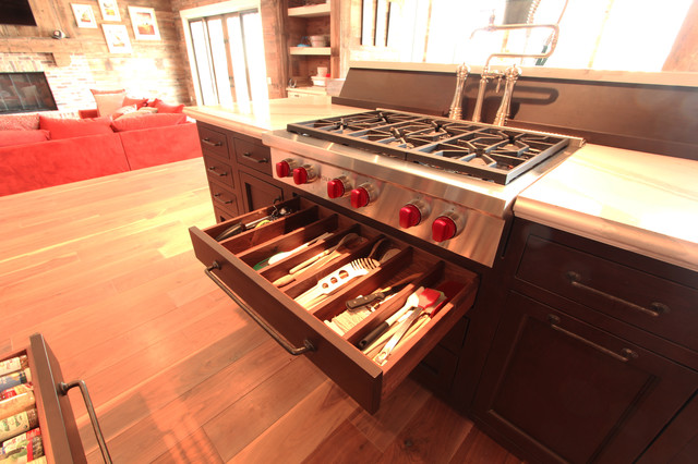 Island Cooktop With Pot Filler Behind And Utensil Drawer Under