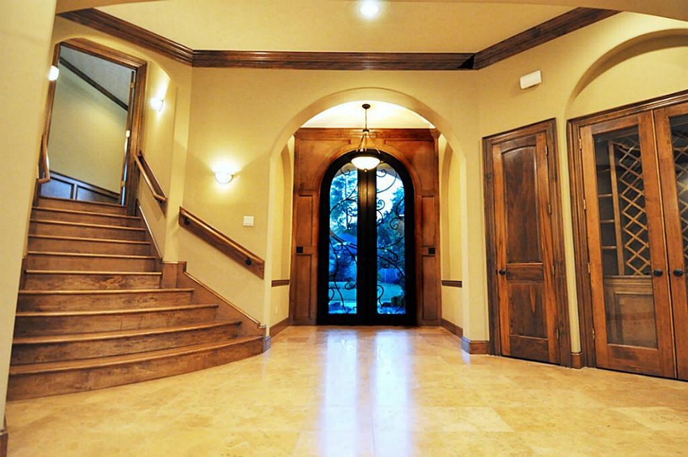 Design ideas for a large traditional foyer in San Diego with beige walls, ceramic floors, a double front door, a glass front door and beige floor.