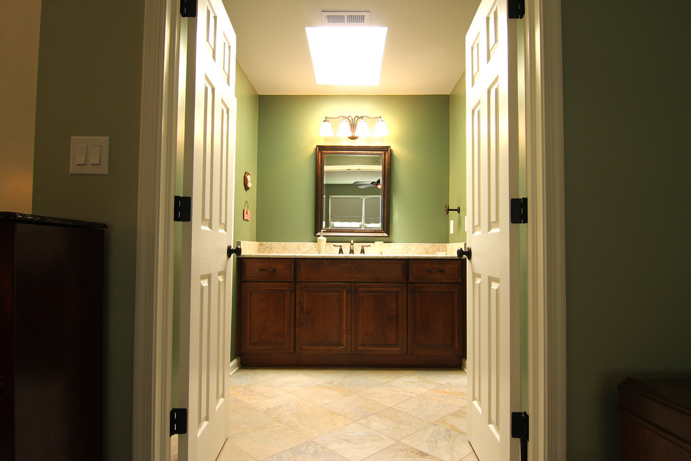 Design ideas for a mid-sized traditional master bathroom in Other with an undermount sink, raised-panel cabinets, medium wood cabinets, granite benchtops, an alcove shower, a two-piece toilet, beige tile, porcelain tile, green walls and porcelain floors.