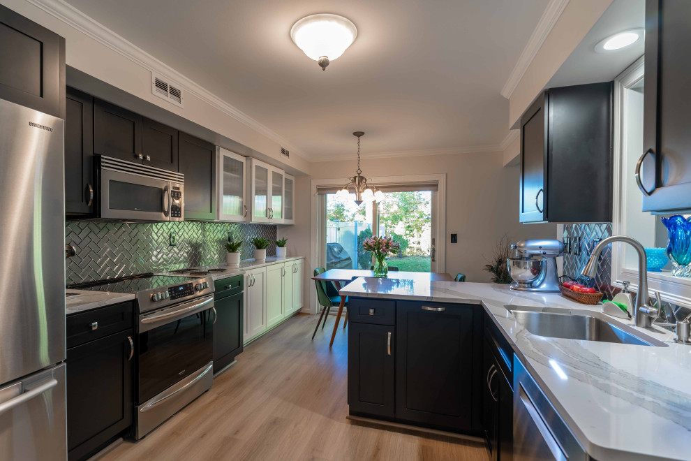 Example of a small trendy galley laminate floor and brown floor eat-in kitchen design in Other with an undermount sink, recessed-panel cabinets, black cabinets, quartz countertops, gray backsplash, porcelain backsplash, stainless steel appliances, no island and white countertops