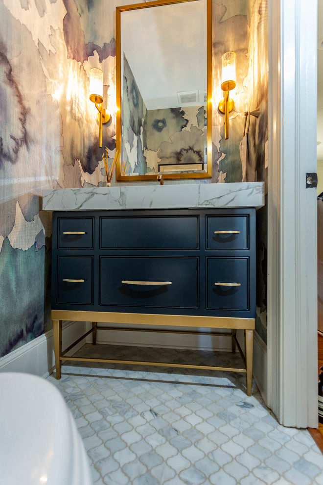 Inspiration for a mid-sized transitional powder room in Charlotte with beaded inset cabinets, black cabinets, white benchtops, multi-coloured walls, marble benchtops and white floor.