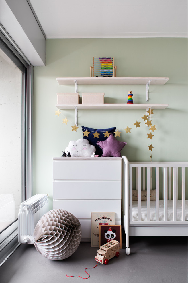 Design ideas for a mid-sized contemporary gender-neutral nursery in Milan with green walls, concrete floors and grey floor.