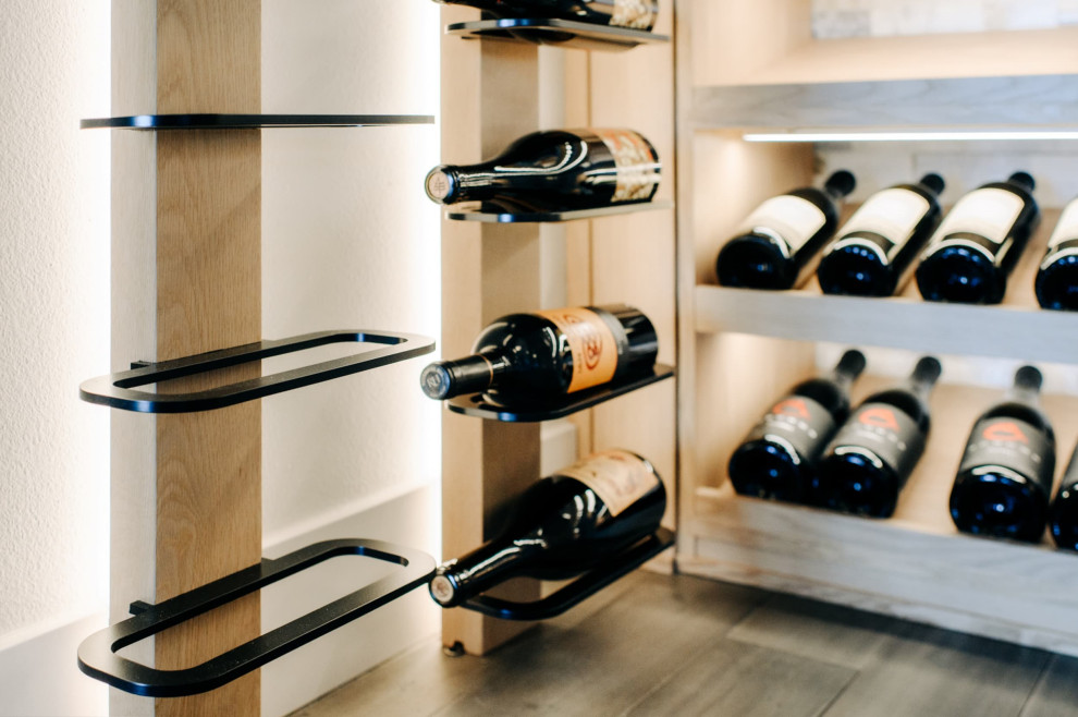 This is an example of a small modern wine cellar in Portland with medium hardwood floors, display racks and brown floor.