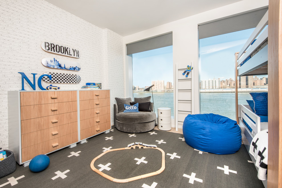 Photo of a contemporary kids' room for kids 4-10 years old and boys in New York with grey walls, light hardwood floors and grey floor.