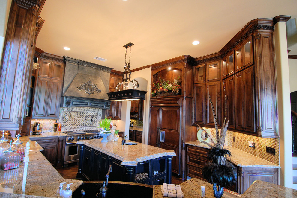 Photo of a mid-sized traditional u-shaped separate kitchen in Dallas with raised-panel cabinets, dark wood cabinets, granite benchtops, beige splashback, glass tile splashback, stainless steel appliances and with island.