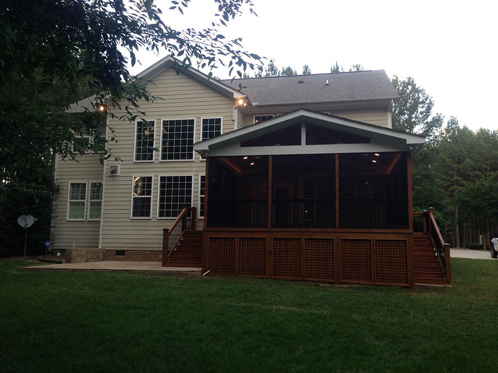 Deck - mid-sized transitional backyard deck idea in Raleigh with a roof extension