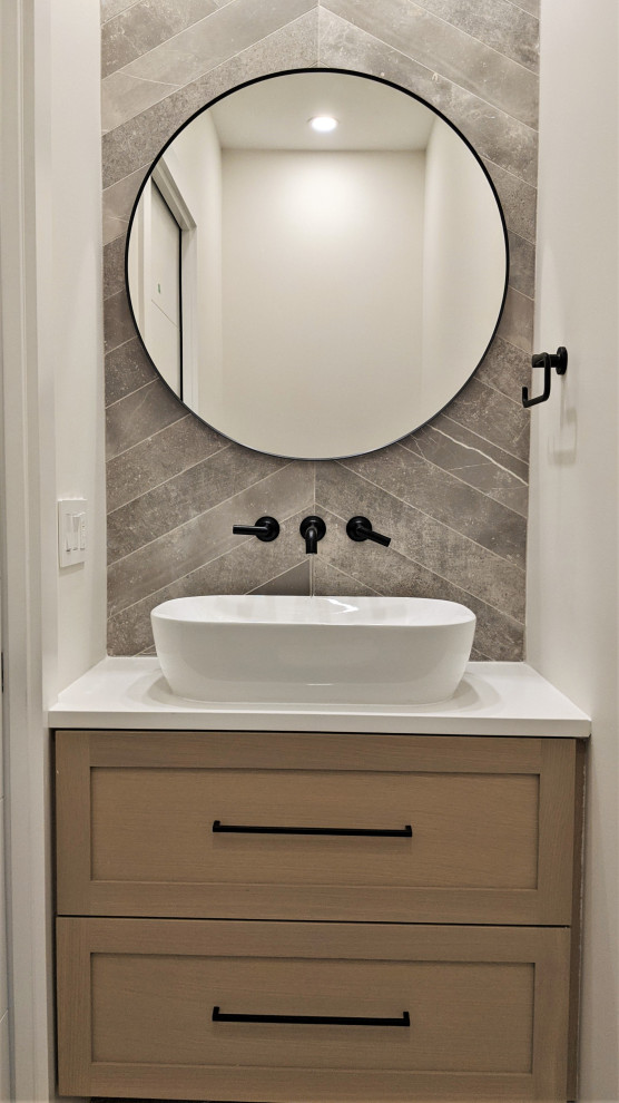 Photo of a small contemporary cloakroom in Vancouver with shaker cabinets, beige cabinets, a two-piece toilet, grey tiles, porcelain tiles, grey walls, porcelain flooring, a vessel sink, quartz worktops, grey floors, white worktops and a built in vanity unit.