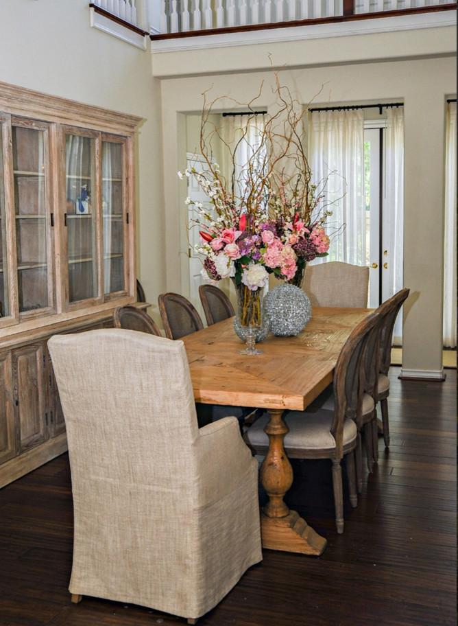 This is an example of a mid-sized traditional dining room in Los Angeles with beige walls, dark hardwood floors and no fireplace.