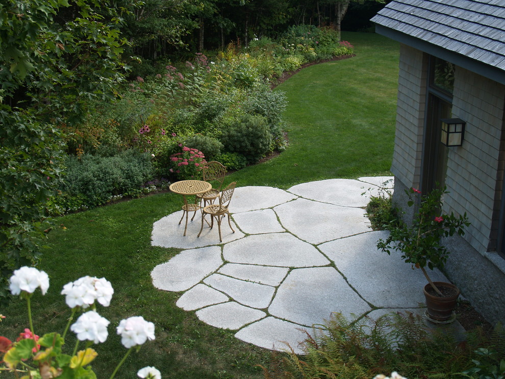 Patio - mid-sized rustic side yard stone patio idea with no cover