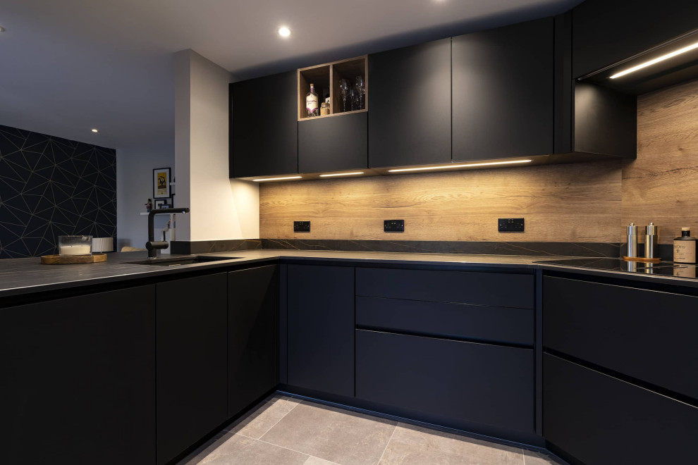 Design ideas for a small u-shaped eat-in kitchen in Oxfordshire with an undermount sink, beaded inset cabinets, black cabinets, quartzite benchtops, green splashback, timber splashback, stainless steel appliances, ceramic floors and multi-coloured benchtop.