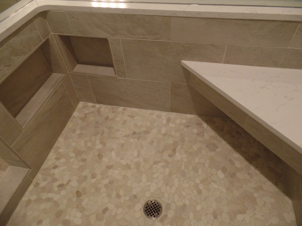 Example of a large transitional master gray tile and porcelain tile porcelain tile corner shower design with an undermount sink, shaker cabinets, white cabinets, quartz countertops, an undermount tub, a two-piece toilet and blue walls