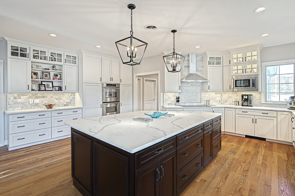 Eat-in kitchen - huge transitional u-shaped medium tone wood floor and brown floor eat-in kitchen idea with an undermount sink, beaded inset cabinets, dark wood cabinets, quartz countertops, multicolored backsplash, marble backsplash, stainless steel appliances, an island and white countertops
