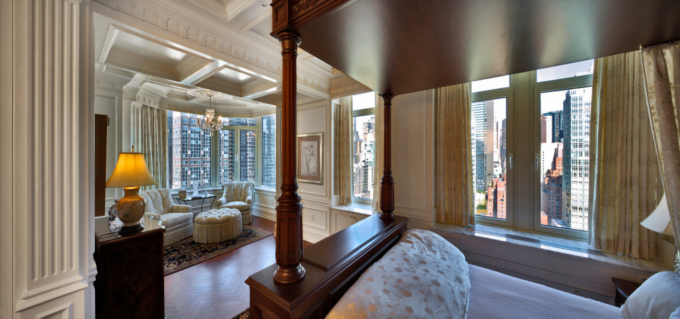 Inspiration for an expansive victorian master bedroom in New York with white walls, medium hardwood flooring, no fireplace, brown floors, a coffered ceiling and panelled walls.