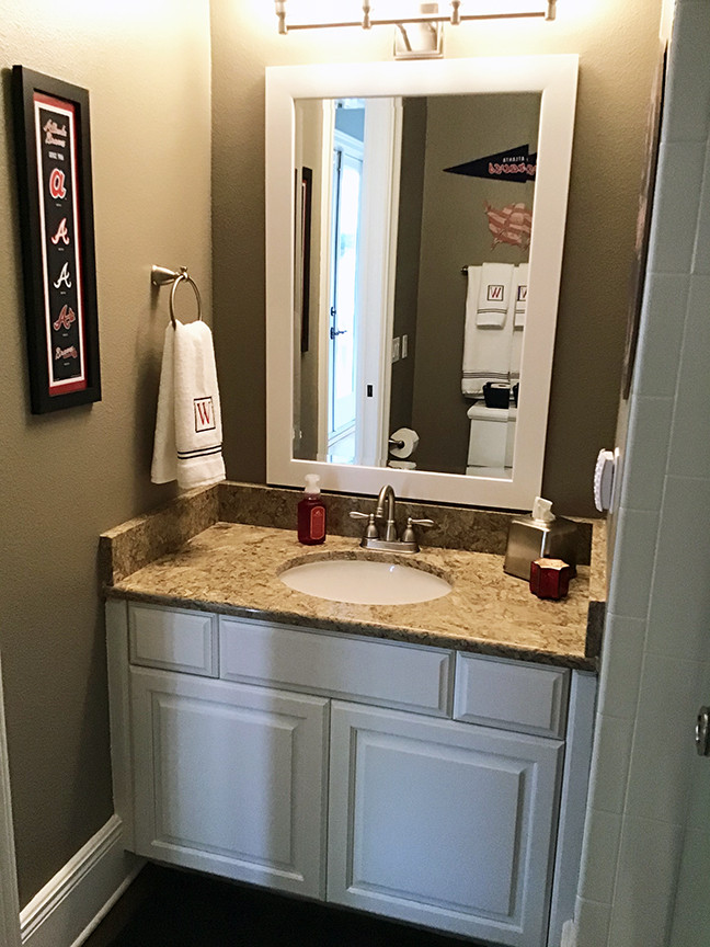 Photo of a small classic bathroom in Orlando with raised-panel cabinets, white cabinets, a two-piece toilet, grey walls, vinyl flooring, a submerged sink, granite worktops, brown floors, beige worktops, a single sink and a built in vanity unit.