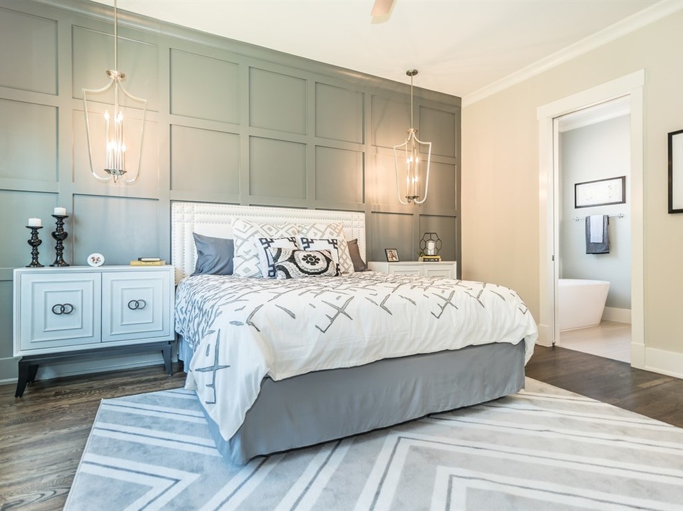 This is an example of an arts and crafts master bedroom in Raleigh with beige walls, dark hardwood floors and no fireplace.