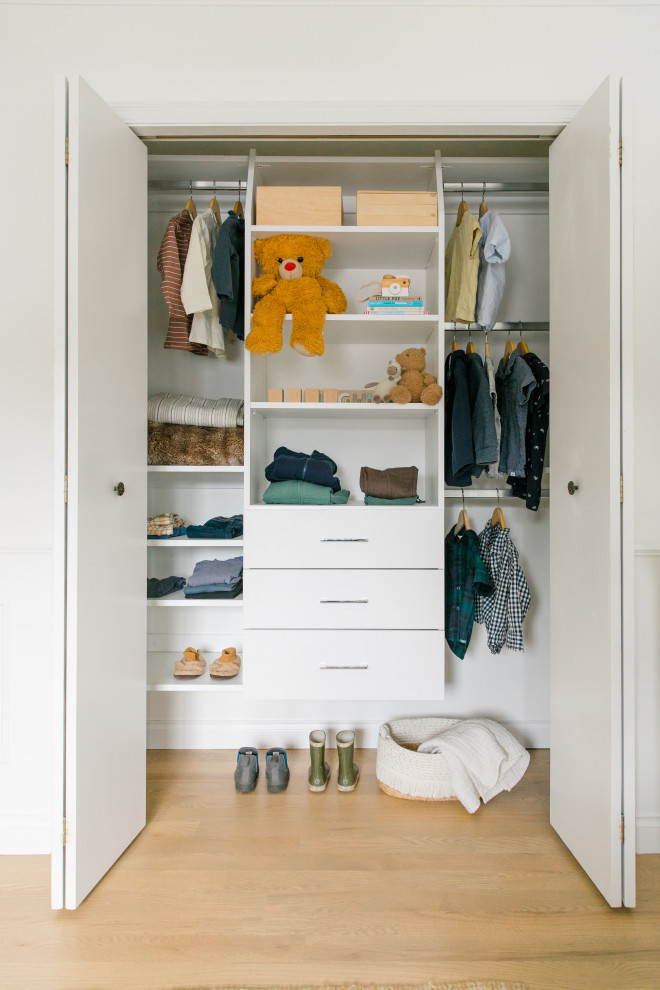 Reach-in closet - small transitional light wood floor reach-in closet idea in Other with flat-panel cabinets and white cabinets