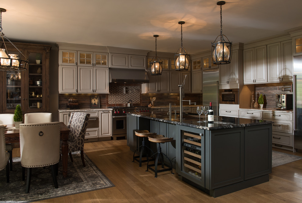 Inspiration for a huge transitional galley light wood floor kitchen remodel with raised-panel cabinets, gray cabinets, quartz countertops, multicolored backsplash, stone tile backsplash, stainless steel appliances and an island