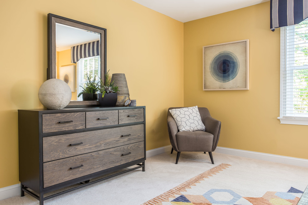 This is an example of an expansive transitional kids' bedroom for kids 4-10 years old and boys in Columbus with yellow walls, carpet and beige floor.