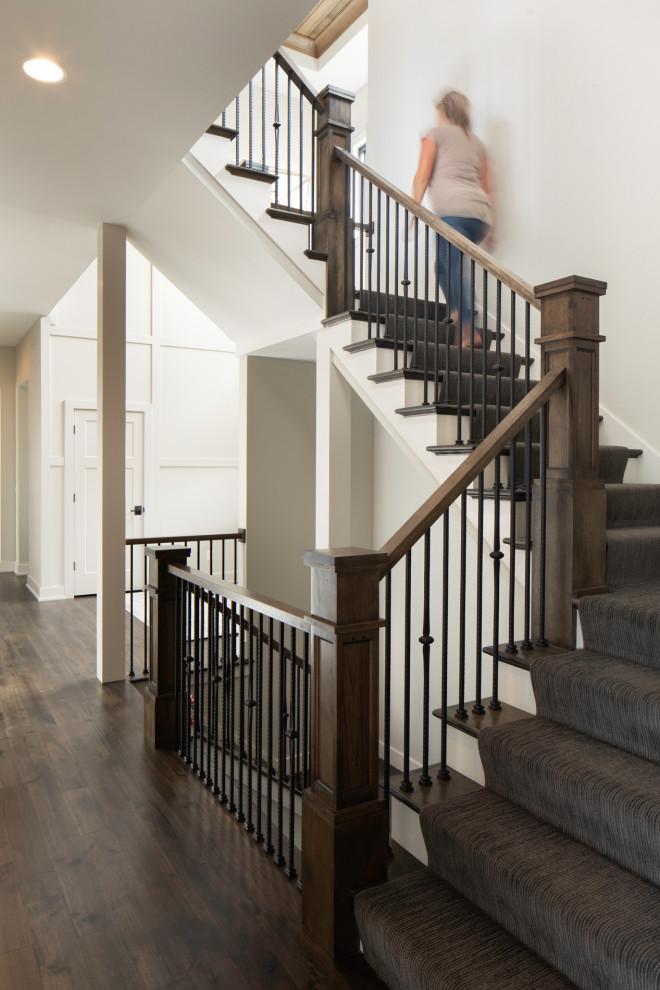 Expansive transitional staircase in Milwaukee with wood walls.