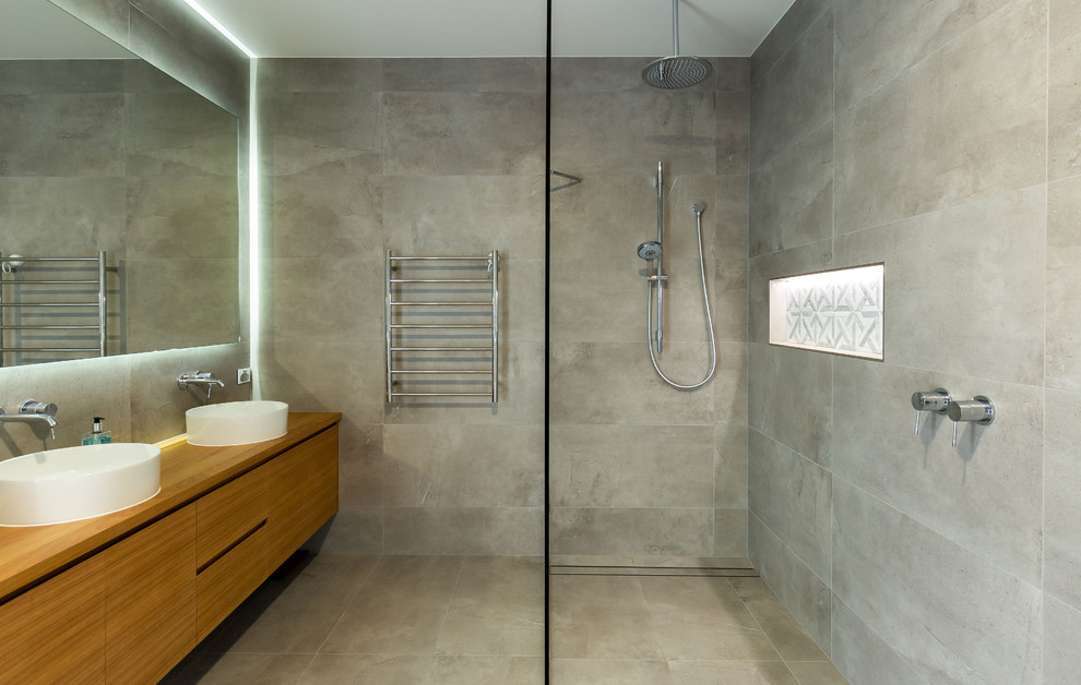 Inspiration for a mid-sized modern master bathroom in Gold Coast - Tweed with light wood cabinets, an open shower, gray tile, grey walls, wood benchtops, grey floor and an open shower.