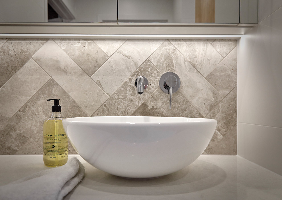 Inspiration for a small contemporary 3/4 bathroom in Other with light wood cabinets, an open shower, a two-piece toilet, gray tile, white walls, ceramic floors, a vessel sink, engineered quartz benchtops, limestone, grey floor, an open shower and white benchtops.