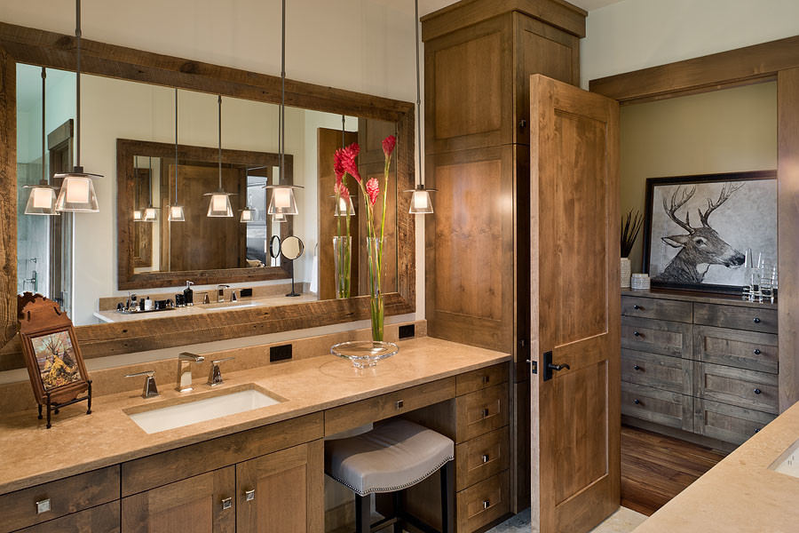 Bathroom - large transitional master beige floor bathroom idea with shaker cabinets, medium tone wood cabinets, an undermount sink, limestone countertops and beige countertops