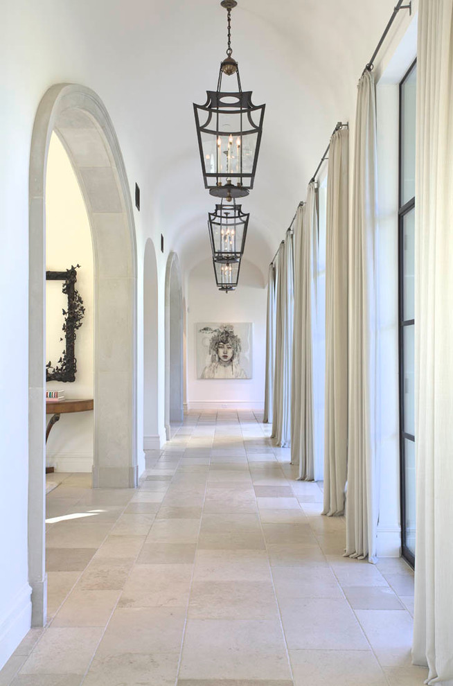 This is an example of a mediterranean hallway in Dallas with limestone floors.
