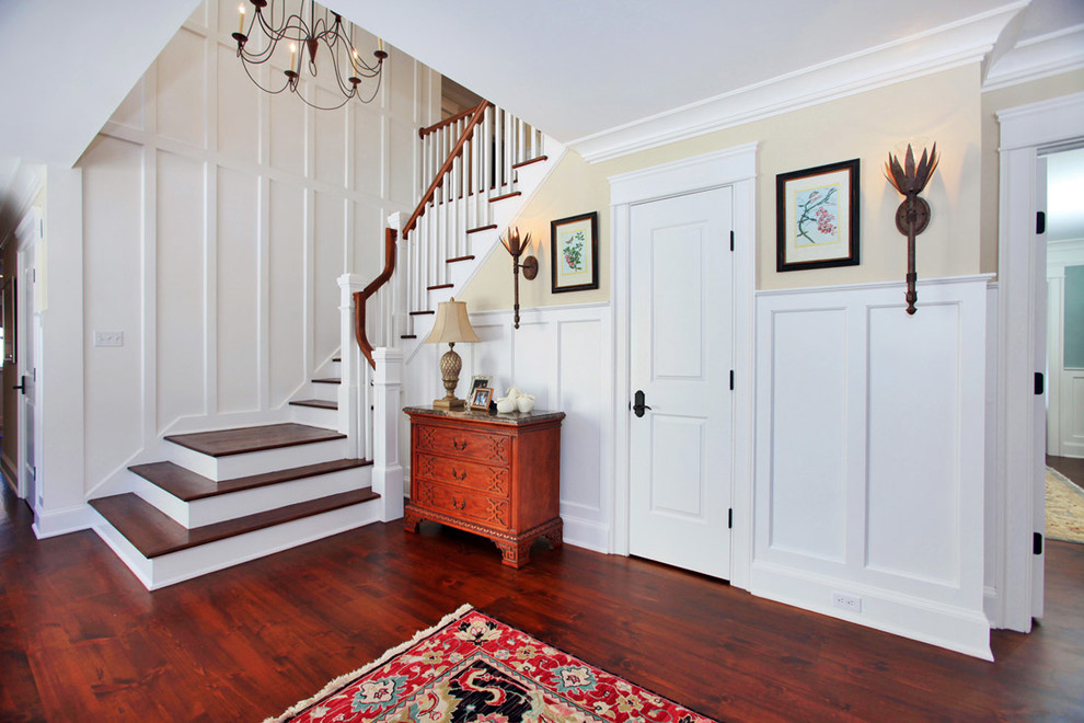 This is an example of a country wood u-shaped staircase in New York with wood railing and painted wood risers.