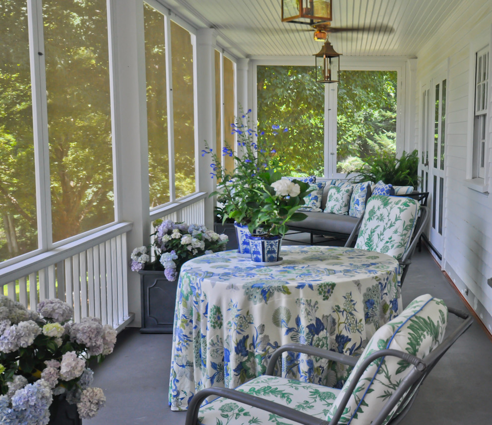 Photo of a mid-sized traditional backyard screened-in verandah in Bridgeport with concrete slab and a roof extension.