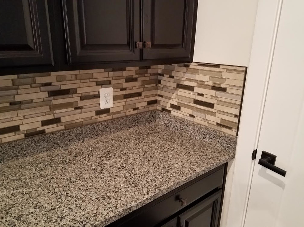 Example of a transitional dark wood floor and brown floor eat-in kitchen design in DC Metro with a drop-in sink, dark wood cabinets, granite countertops, multicolored backsplash, glass tile backsplash, stainless steel appliances and multicolored countertops