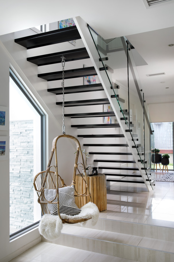 Mid-sized contemporary painted wood straight staircase in Brisbane with painted wood risers and metal railing.