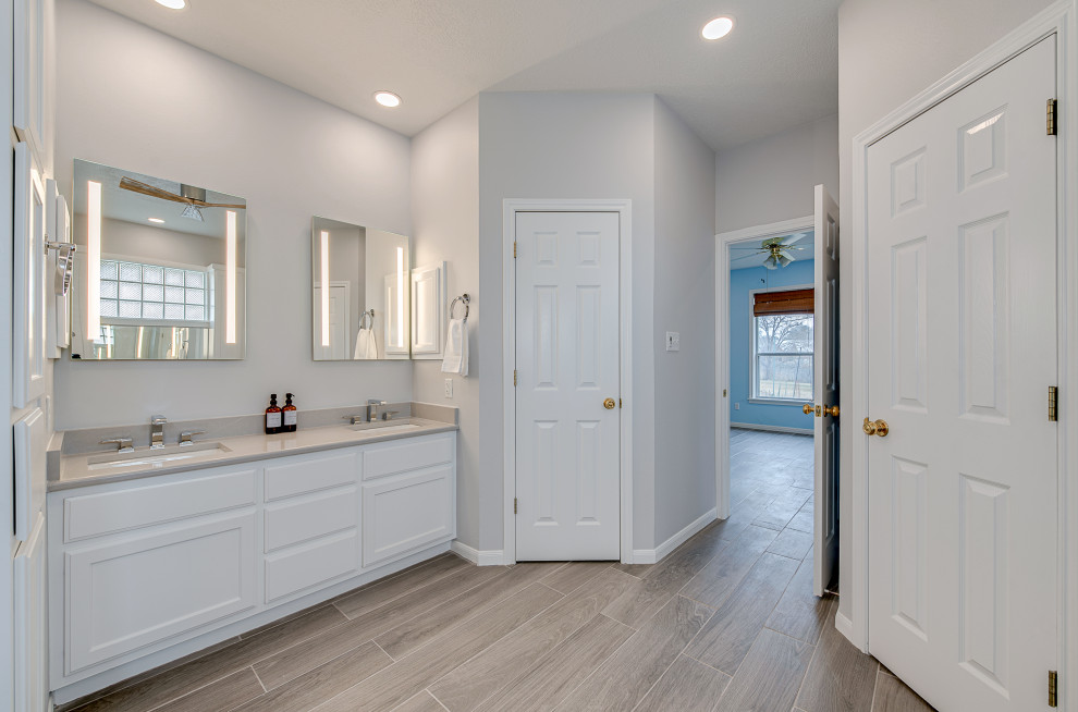 This is an example of a large modern master bathroom in Austin with recessed-panel cabinets, white cabinets, a double shower, gray tile, mosaic tile, white walls, wood-look tile, an undermount sink, engineered quartz benchtops, grey floor, an open shower, grey benchtops, a double vanity and a built-in vanity.
