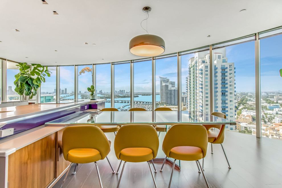 Inspiration for a contemporary dark wood floor and brown floor dining room remodel in Miami with white walls