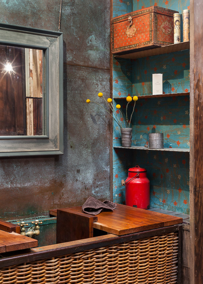 Industrial bathroom in Portland with a pedestal sink, open cabinets, wood benchtops, metal tile and concrete floors.