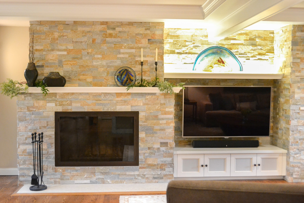 This is an example of a mid-sized contemporary formal enclosed living room in Cedar Rapids with beige walls, medium hardwood floors, a standard fireplace, a stone fireplace surround and a wall-mounted tv.