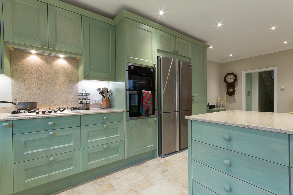 Photo of a large country u-shaped eat-in kitchen in London with an integrated sink, shaker cabinets, medium wood cabinets, solid surface benchtops, beige splashback, stone slab splashback, stainless steel appliances, porcelain floors and no island.